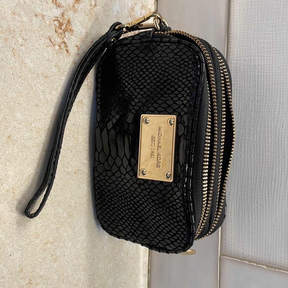 Michael Kors wristlet -two zip compartments.  Dimensions are 6 1/2 x 4